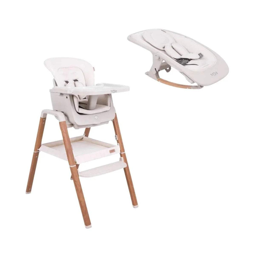 Convertible highchair rocker with white padded seat, harness, and light wood legs