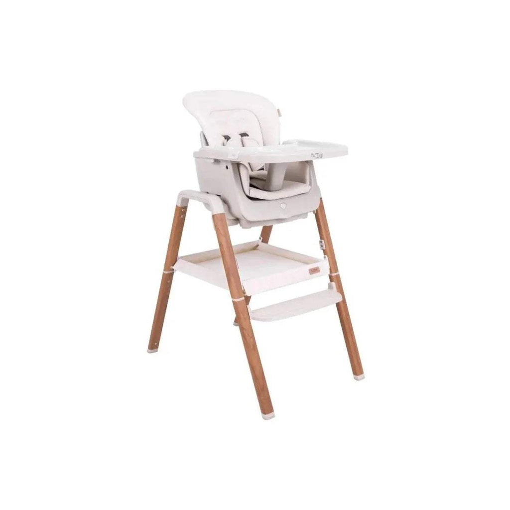 Convertible highchair with white seat, tray, and light wood frame