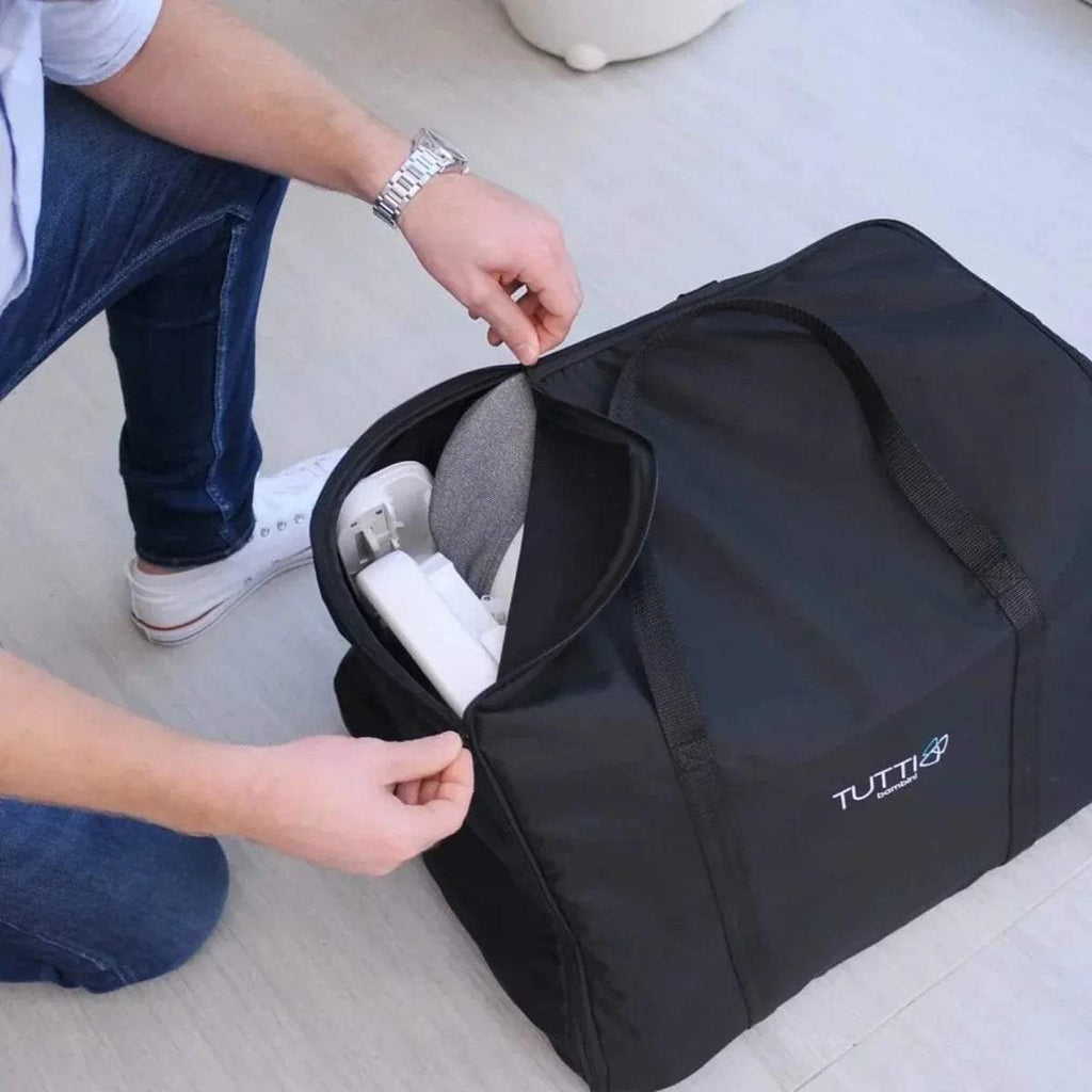 Black travel bag with open zipper for high chair parts being packed