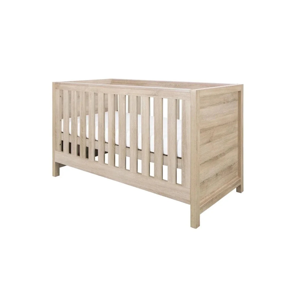 Light oak cot bed with vertical slats and raised sides, front view.