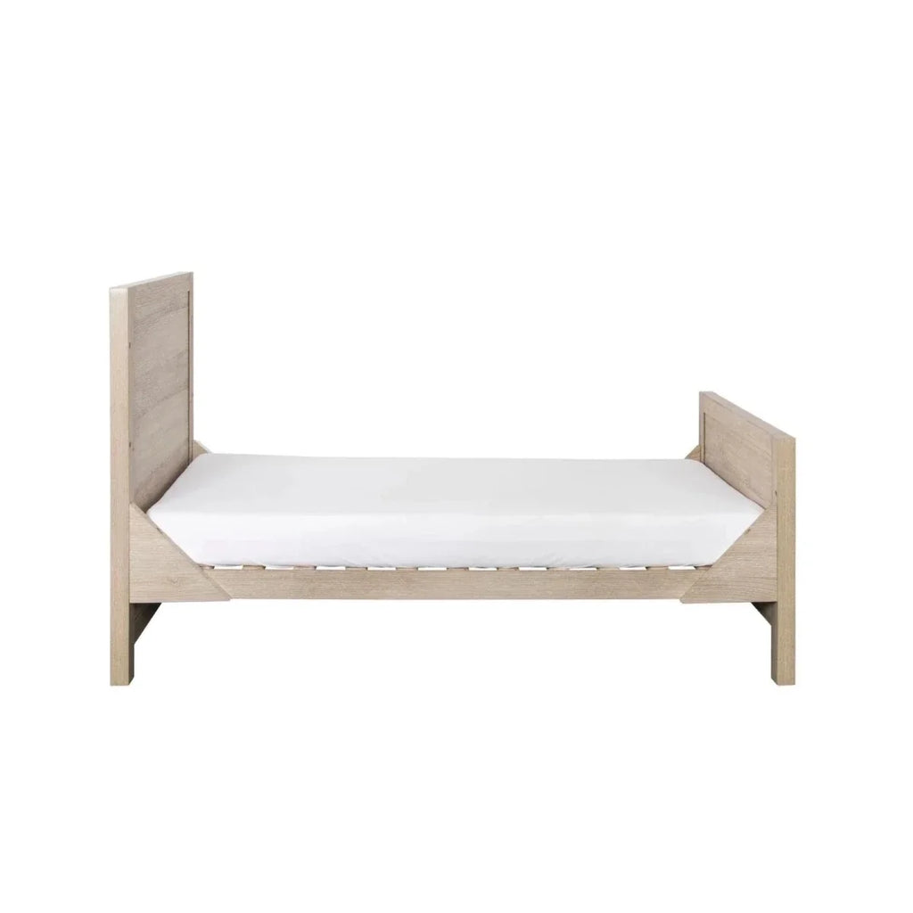 Light oak toddler bed frame with white mattress, flat headboard and footboard