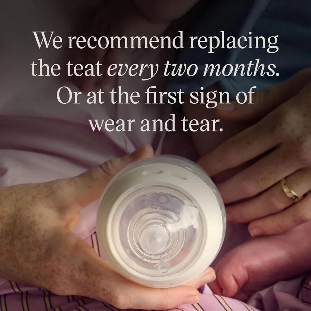Fast flow baby bottle teat in bottle opening held by hands