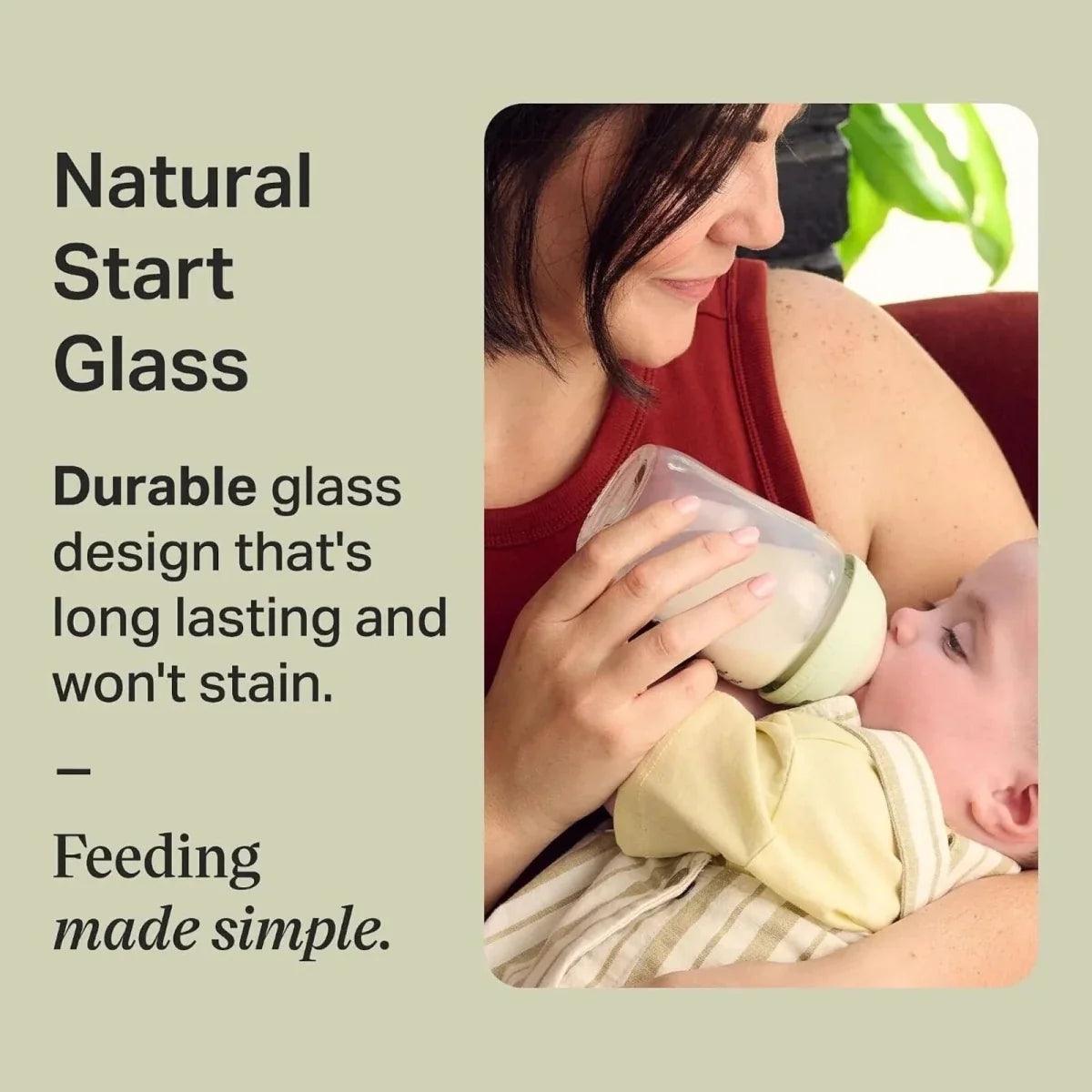 150ml baby glass bottle with green base being used for feeding