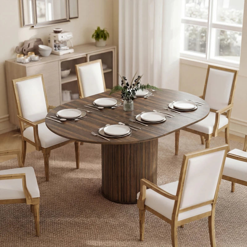 Dark walnut round dining table with pedestal base and dining chairs around the top