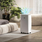 White dehumidifier with front grille and caster wheels, showing visible mist stream.