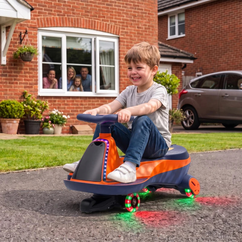 Orange kids electric wiggle car with RGB underglow, child riding outdoors