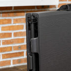 Side view of dark grey foldable patio table with locking support bar