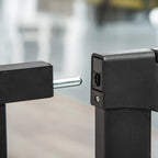 Black pressure-fit pet gate latch and mounting post, close-up detail