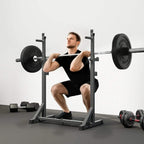 Adjustable barbell squat rack with safety hooks, loaded barbell, and weight plates