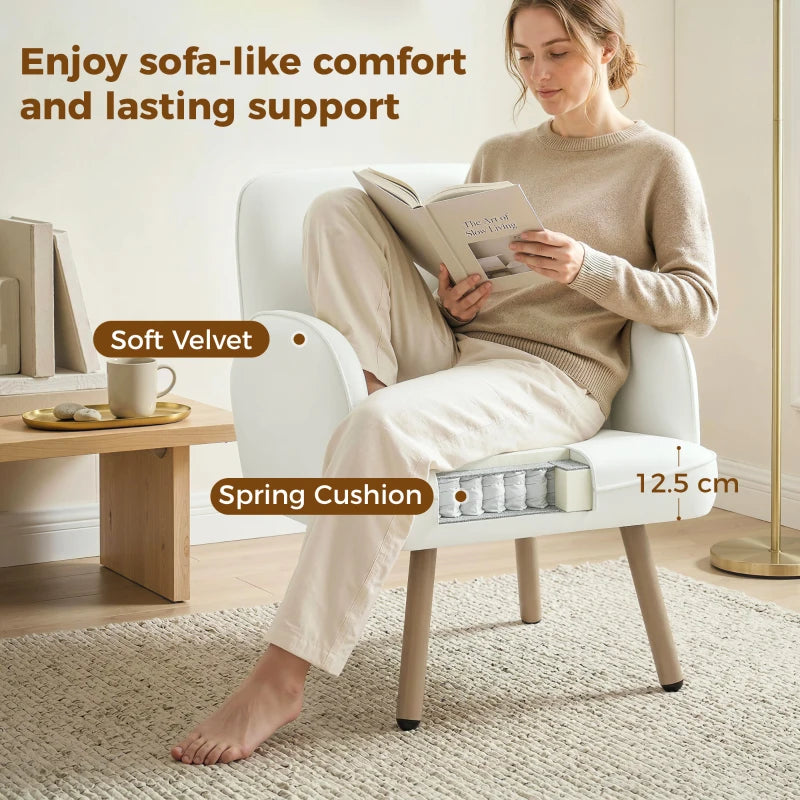 Cream velvet armchair with spring seat cushion and rounded armrests, supported by wooden legs