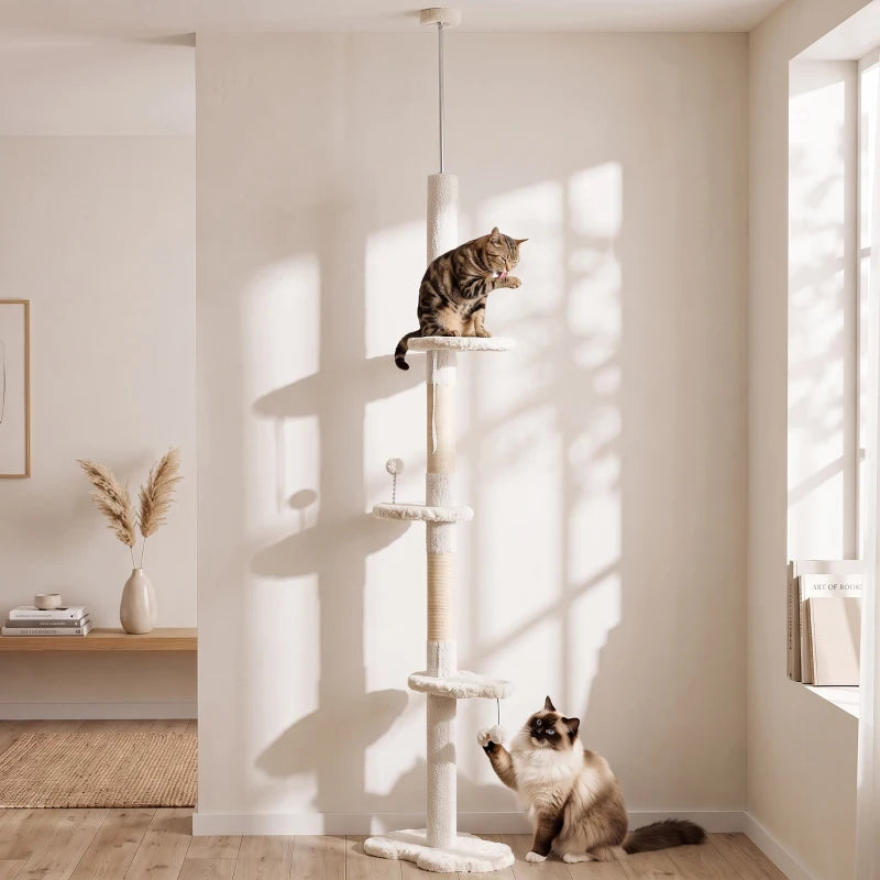 Beige cat climbing tower with multiple perches and sisal posts, with cats playing