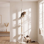 Beige cat climbing tower with multiple perches and sisal posts, with cats playing