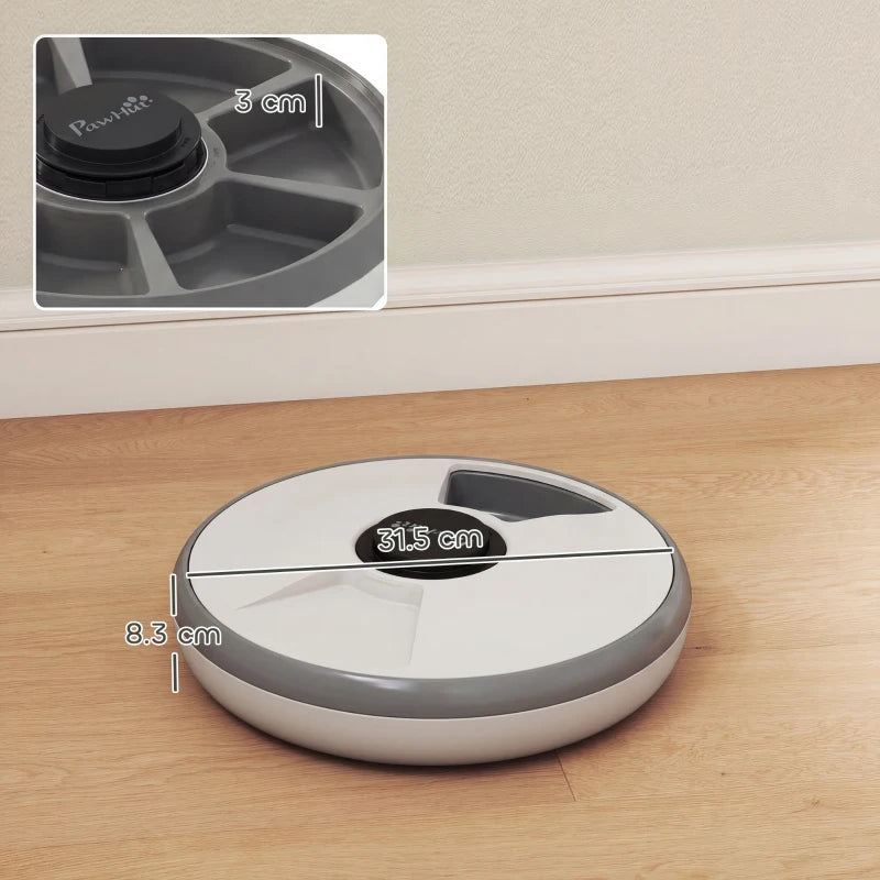 Grey automatic cat feeder on floor with top button and side dimensions