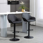 Pair of black height-adjustable bar stools with backs, armrests, and circular footrests