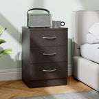 Black three-drawer bedside table with curved silver handles
