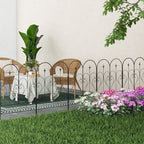 Black decorative metal fence panels with heart arches and scrollwork beside flowers and patio seating