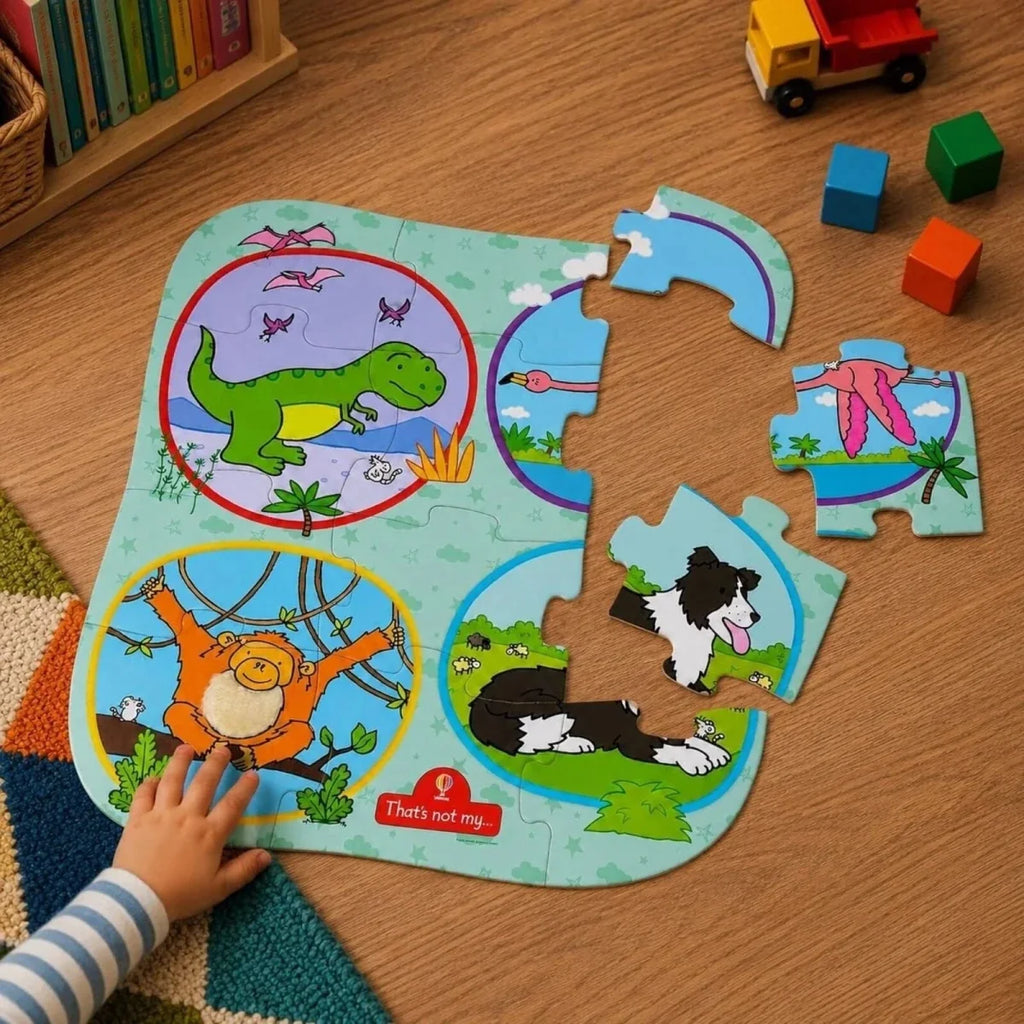 Animal floor puzzle mat with dinosaur, cat, and whale pieces on top