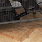 Bottom of grey wire cage with removable tray area, ramp, and wheels.