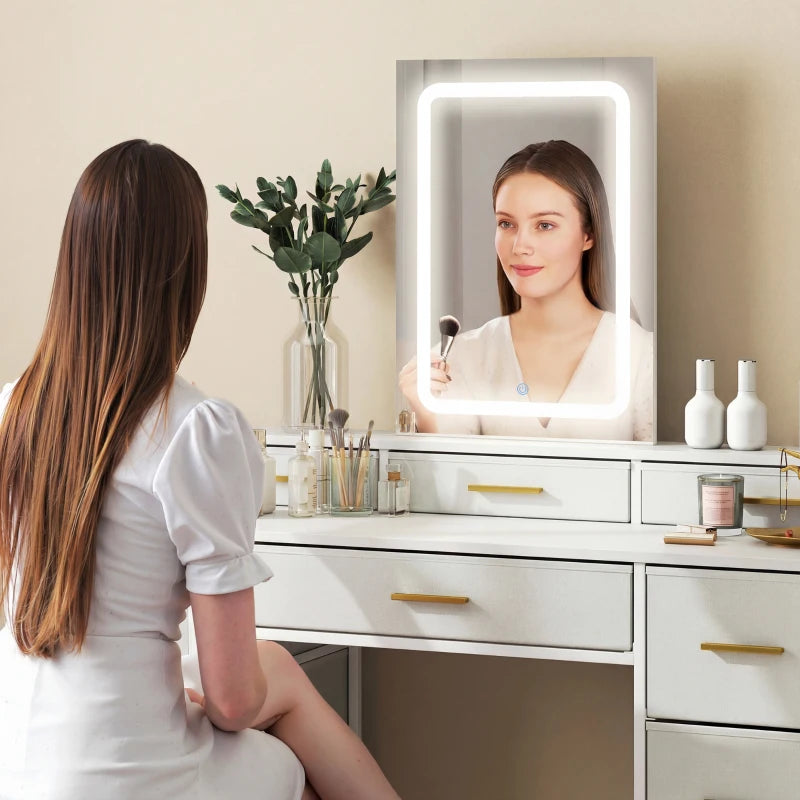 White vanity desk with LED mirror, gold drawer pulls, and countertop
