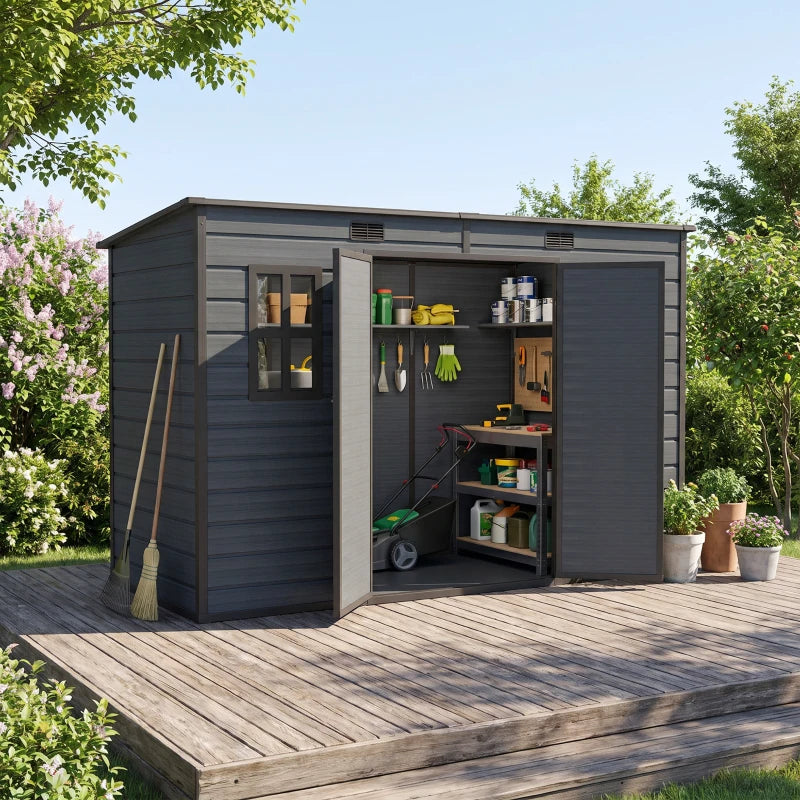Dark grey resin storage shed with open doors, interior shelving, and side windows