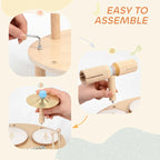 Wooden baby drum kit shown during assembly with mallet and cymbal pieces