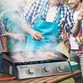 Portable tabletop gas griddle grill with three burner controls and black cooking surface
