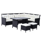 Black rattan corner dining sofa set with white cushions, coffee table, and footstools