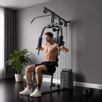 Black multifunction home gym machine with lat pulldown arms, padded seat, and weight stack