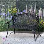 Black cast aluminum garden bench with arched lattice back and slatted seat, full view