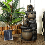 Garden patio view of cascading jar water fountain in dark grey with golden highlights