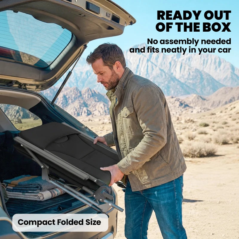 Black folding camping chair being stored compactly in a car trunk space
