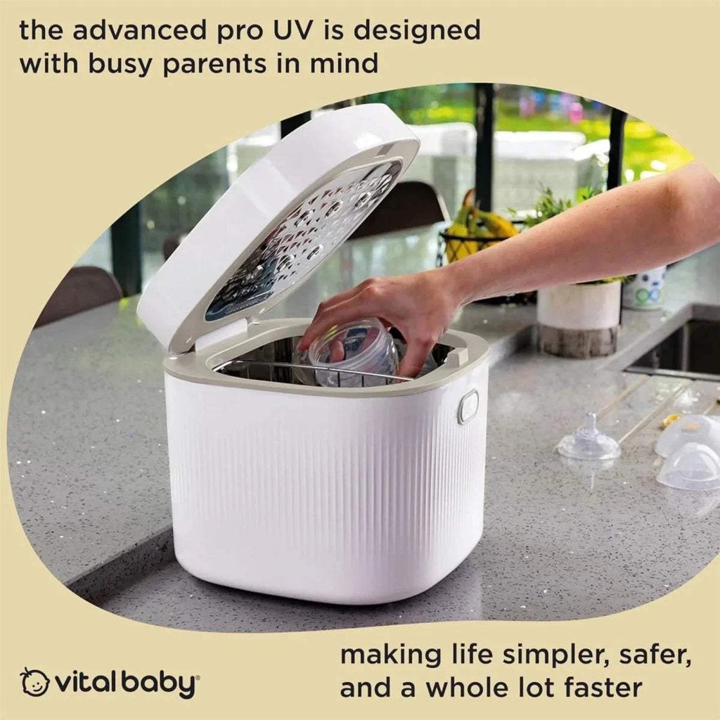 Smoky blue baby UV steriliser and dryer with open lid, hands placing items inside