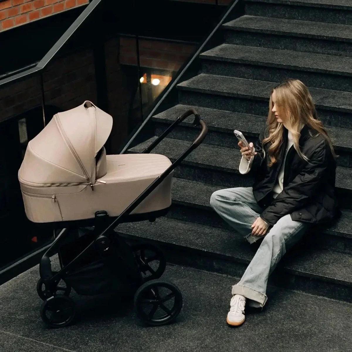 Fog Venicci Claro stroller parked on steps with canopy and seat unit