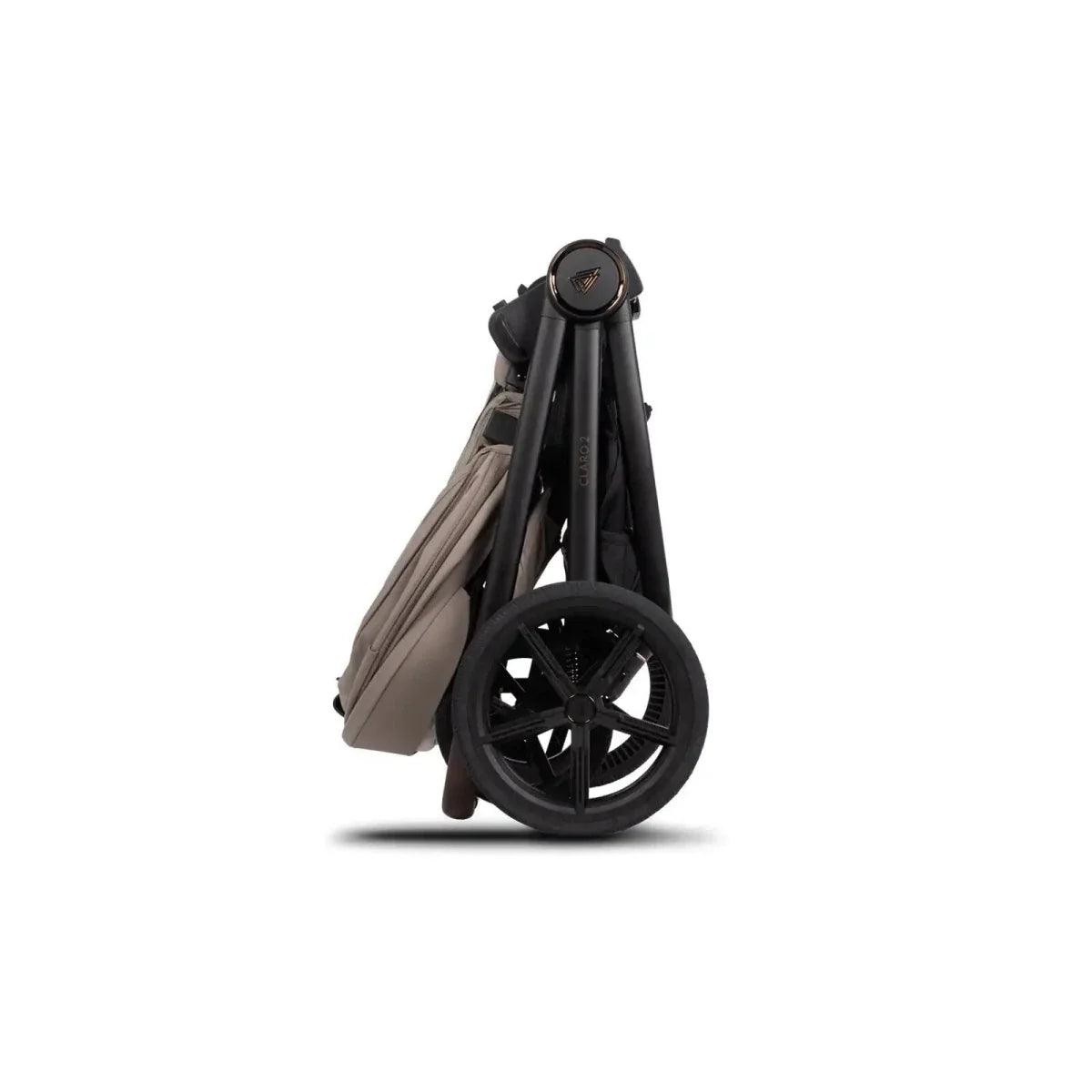 Black carrycot wheels and folded stroller frame with beige fabric