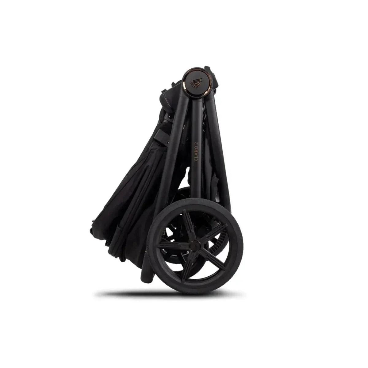 Folded black stroller frame with wheels and canopy