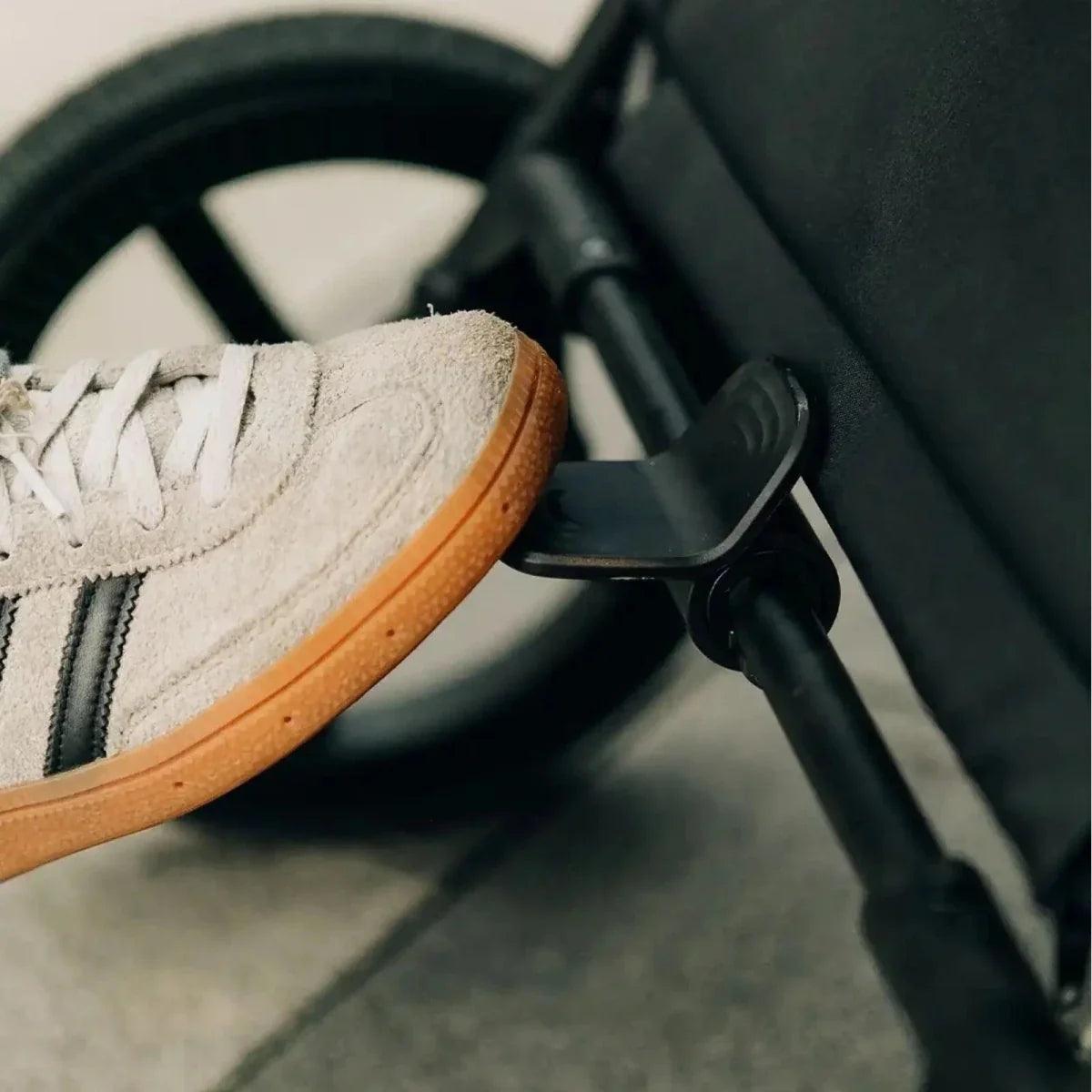 Stroller footrest with light suede shoe and laces