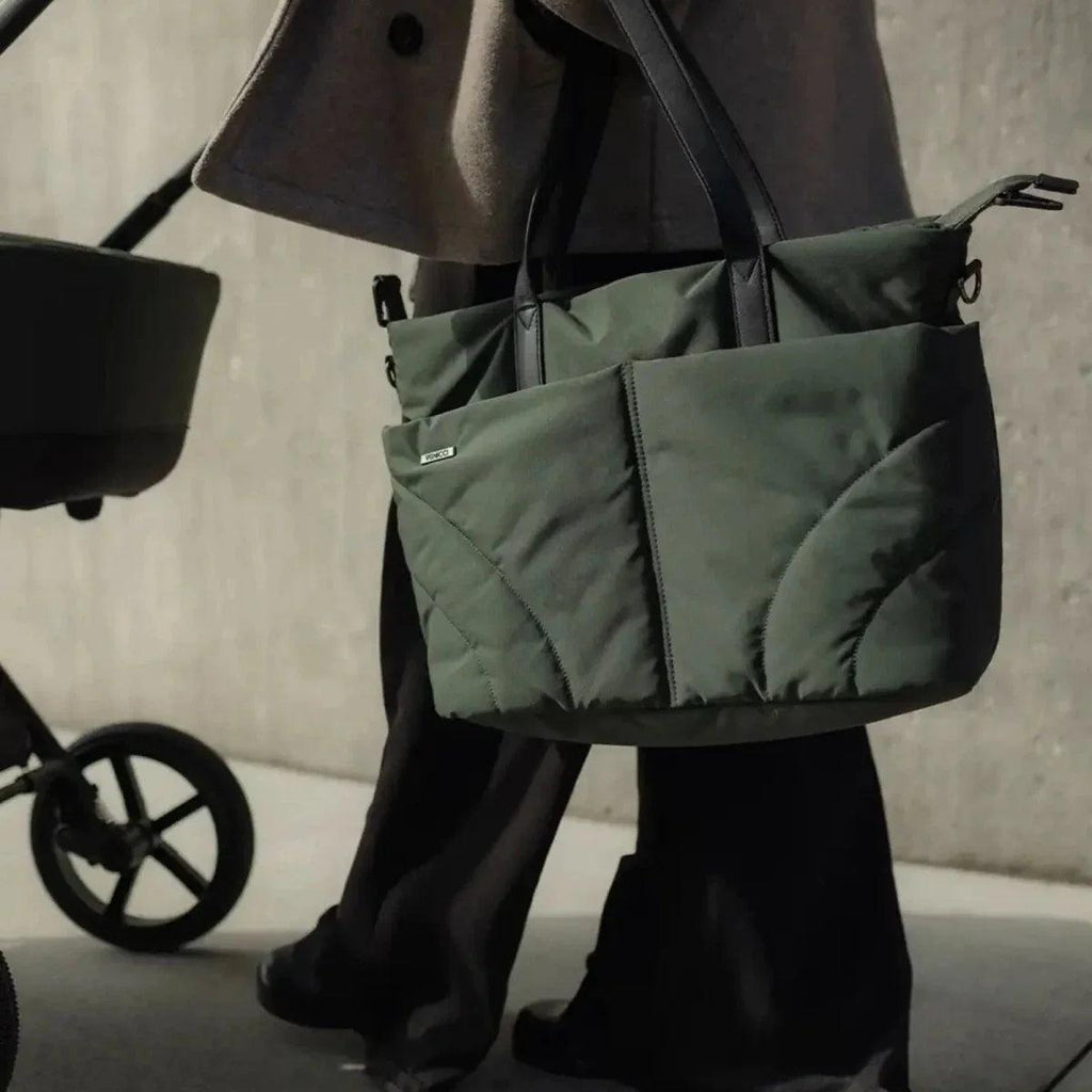 Pair of green stroller storage bags with quilted padding and handles