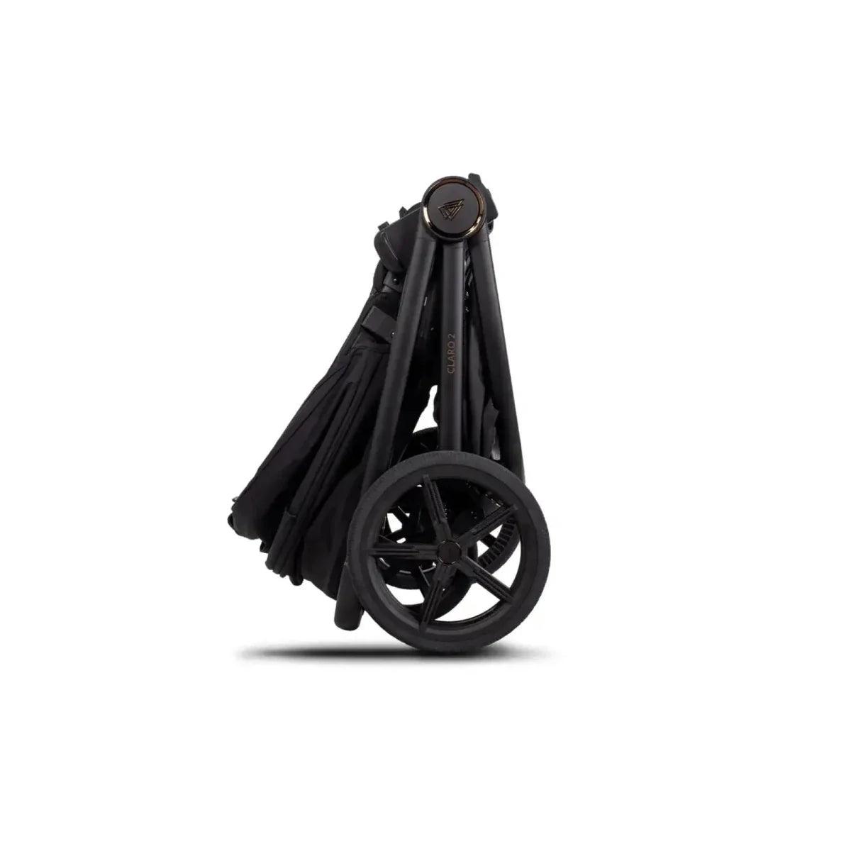 Folded stroller carrycot shell with canopy, dark fabric and compact frame wheels