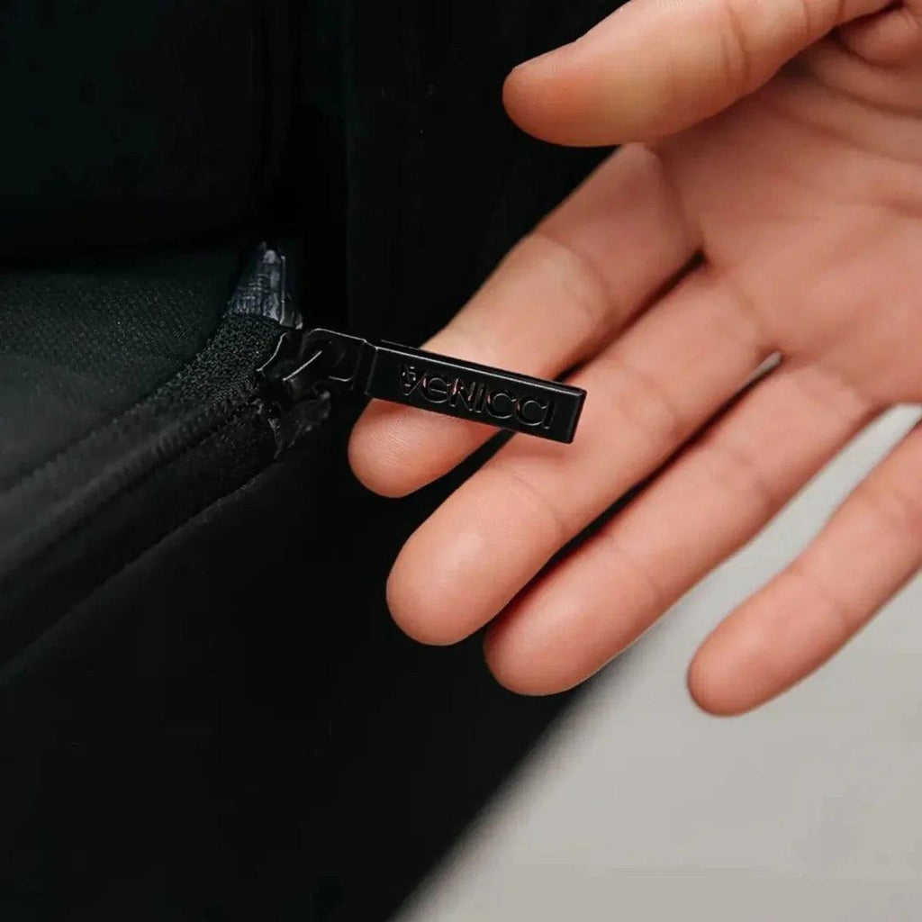 Venicci logo label on black stroller fabric strap