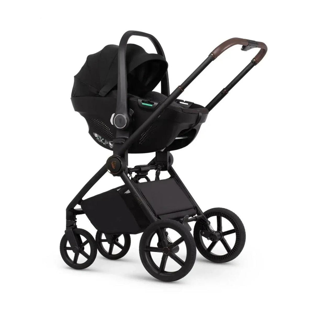 Black stroller with hooded carrycot, black frame, and brown handlebar