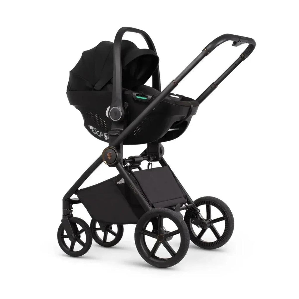 Black stroller with carrycot and seat unit, black canopy and four-wheel frame