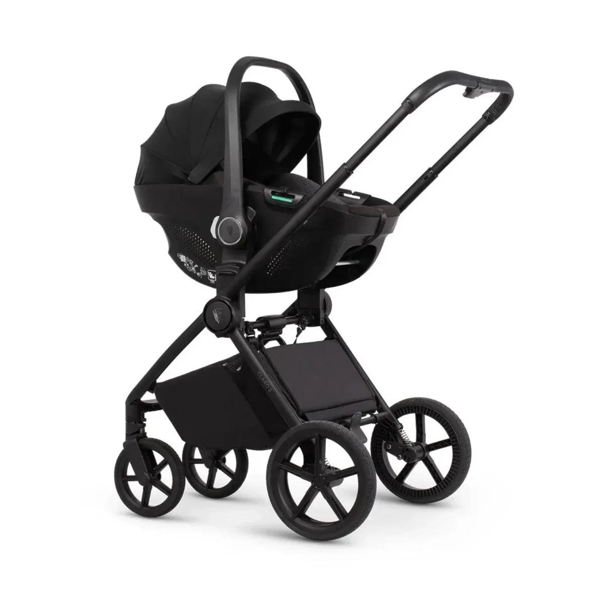 Black stroller with carrycot, seat unit, front wheels, and canopy