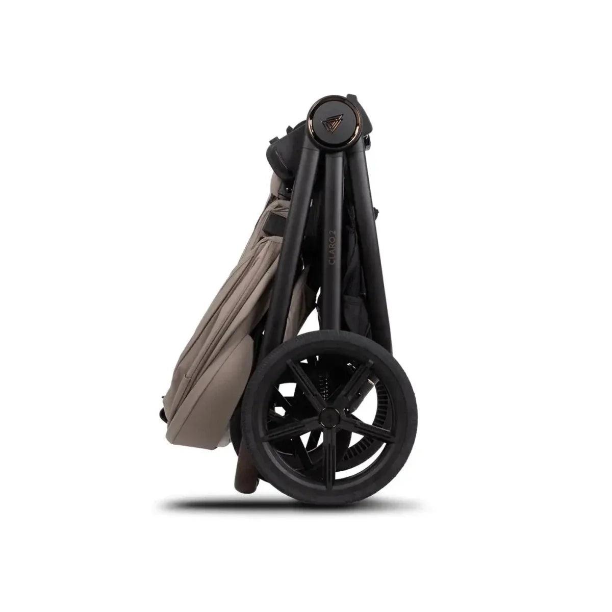 Stroller frame with beige carrycot shell and black wheels