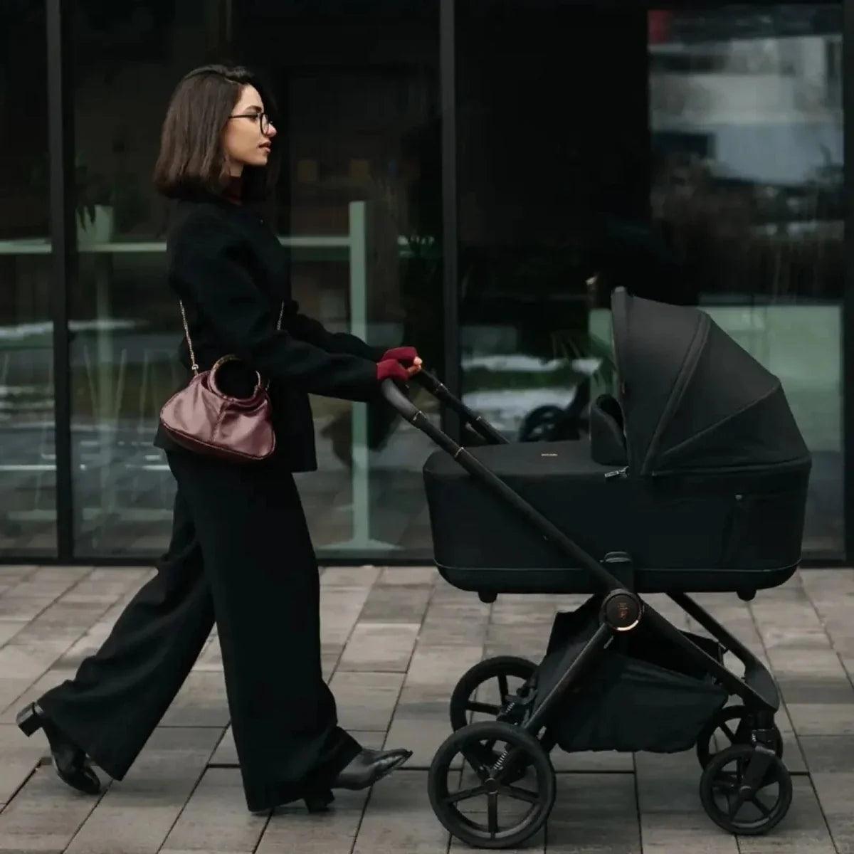 Beige stroller with dark frame, canopy, and handlebar