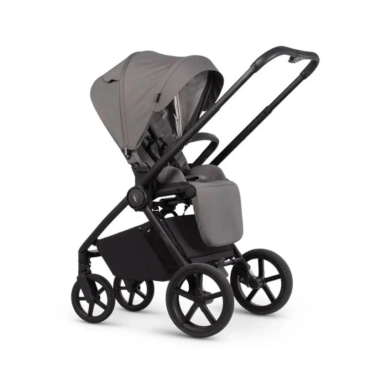 Gray stroller seat unit with black frame and wheels, viewed from the side