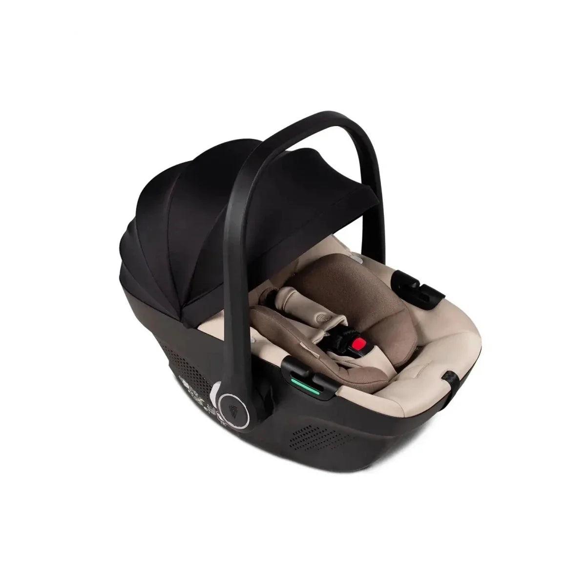 Beige car seat insert inside black carrycot with handle, angled view