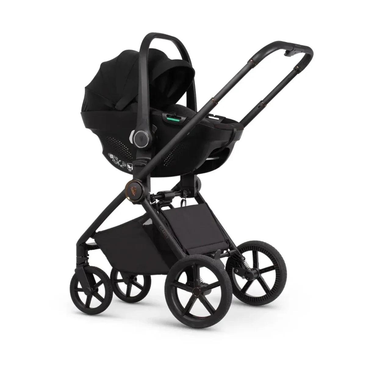 Stroller with carrycot and seat attachments, black fabric, black wheels and frame
