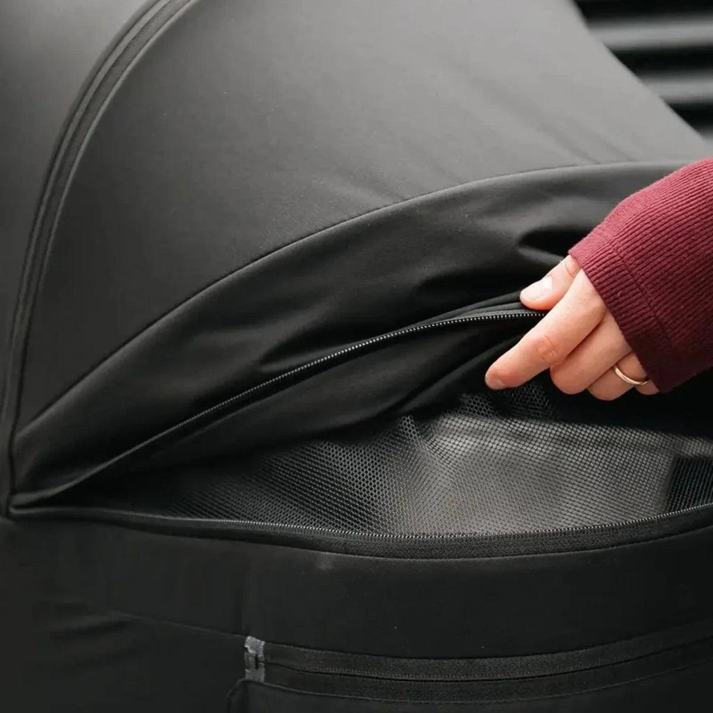 Black stroller canopy with zipper edge and openable storage pocket