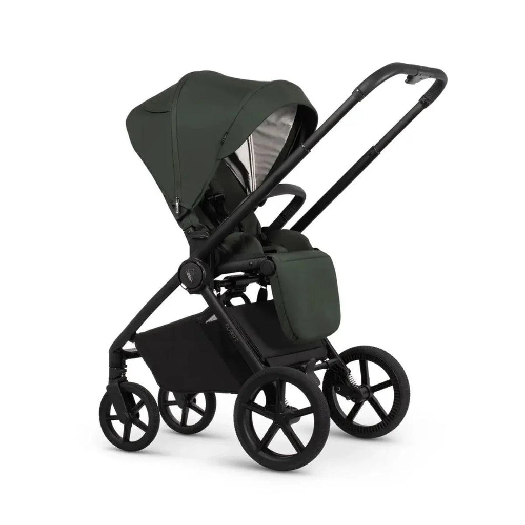 Black stroller with forest green seat and carrycot, wheels and canopy, side angle