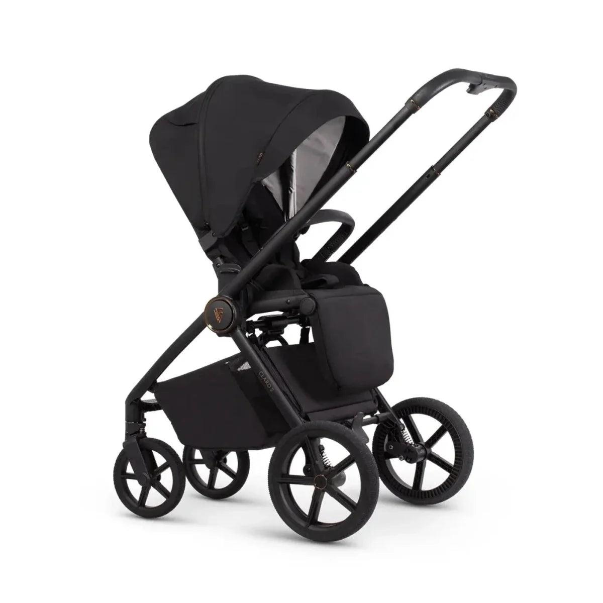 Black 4-in-1 stroller with carrycot and front wheels, side view